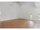 A spacious living room with hardwood floors, high ceilings, a fan, and access to the outside at 1929 Sipes Ave, Sanford, FL 32771