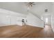 A spacious living room featuring hardwood floors and an open concept design with a kitchen and staircase view at 1929 Sipes Ave, Sanford, FL 32771