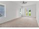 A large main bedroom with carpet, two windows, and access to the backyard via french doors at 1929 Sipes Ave, Sanford, FL 32771