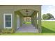 Covered outdoor living space with ceiling fans and a view of the green lawn at 1929 Sipes Ave, Sanford, FL 32771