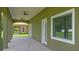Exterior view of covered patio with tiled flooring and traditional architectural columns at 1929 Sipes Ave, Sanford, FL 32771