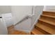 Staircase with hardwood steps and white trim, leading towards a bright, naturally lit entry at 1929 Sipes Ave, Sanford, FL 32771