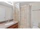 Bathroom featuring a glass-enclosed tiled shower, vanity, and toilet, creating a functional and clean space at 2058 Prospect Ave, Orlando, FL 32814