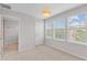 Bright bedroom with three large windows and attached bathroom featuring neutral color palette at 2058 Prospect Ave, Orlando, FL 32814