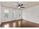 Bright bedroom with a ceiling fan and three windows with access to the outside at 2058 Prospect Ave, Orlando, FL 32814