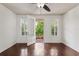 Bedroom with dark wood floors, fan and private balcony, offering a serene retreat at 2058 Prospect Ave, Orlando, FL 32814