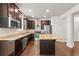 Gourmet kitchen featuring stainless steel appliances, granite countertops, a center island, and ample cabinet space at 2058 Prospect Ave, Orlando, FL 32814