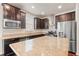 Well-equipped kitchen with stainless steel appliances, granite counters, subway tile, and rich dark wood cabinetry at 2058 Prospect Ave, Orlando, FL 32814