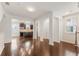 Bright and open living space showcasing wood floors, white columns and views of the kitchen at 2058 Prospect Ave, Orlando, FL 32814