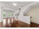 Inviting living room showcasing gleaming hardwood floors, natural light, and an adjacent staircase leading upstairs at 2058 Prospect Ave, Orlando, FL 32814