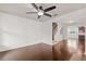 Open-concept living room boasts hardwood floors, and seamless flow to kitchen and staircase at 2058 Prospect Ave, Orlando, FL 32814
