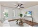 Bright living room with white walls, wood floors, ceiling fan, and modern furnishings at 2058 Prospect Ave, Orlando, FL 32814