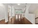 Open-concept layout with sleek wood flooring leading to living spaces and staircase at 2058 Prospect Ave, Orlando, FL 32814