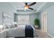 Serene main bedroom featuring tray ceiling, a queen bed, and natural light at 2058 Prospect Ave, Orlando, FL 32814