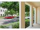 Porch view with thick white pillars overlooking a street with parked cars at 2058 Prospect Ave, Orlando, FL 32814