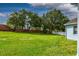Spacious backyard with lush green grass and mature trees, perfect for outdoor activities at 2237 Wintermere Pointe Dr, Winter Garden, FL 34787