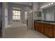 Bright bathroom with a soaking tub, walk-in shower, and dual sink vanity at 2237 Wintermere Pointe Dr, Winter Garden, FL 34787