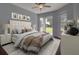 Serene bedroom featuring a plush bed, sliding glass door, and backyard views, creating a tranquil retreat at 2237 Wintermere Pointe Dr, Winter Garden, FL 34787