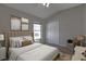 Comfortable bedroom with neutral tones, plush bedding, and a cozy seating area by the window at 2237 Wintermere Pointe Dr, Winter Garden, FL 34787