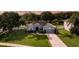 Aerial view of a beautiful single-Gathering home with mature trees and a well-manicured lawn at 2237 Wintermere Pointe Dr, Winter Garden, FL 34787