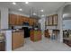 Functional kitchen with wood cabinetry, a center island, and adjacent dining nook enhances everyday living at 2237 Wintermere Pointe Dr, Winter Garden, FL 34787