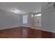Spacious living room with wood floors, abundant natural light, and a decorative chandelier at 2237 Wintermere Pointe Dr, Winter Garden, FL 34787
