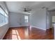 Open-concept living room with hardwood floors, neutral paint, and natural light from multiple windows at 2237 Wintermere Pointe Dr, Winter Garden, FL 34787