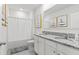 Elegant bathroom with double vanity, granite countertop, and bathtub with shower at 2355 White Lilly Dr, Kissimmee, FL 34747