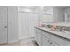 Bathroom featuring double sinks, granite countertops, and a shower with a white curtain at 2355 White Lilly Dr, Kissimmee, FL 34747