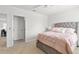 Comfortable bedroom with a tufted headboard and soft pink bedding, perfect for relaxation at 2355 White Lilly Dr, Kissimmee, FL 34747