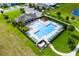 Aerial view of a community pool with a splash fountain, lounge chairs, and lush landscaping at 2355 White Lilly Dr, Kissimmee, FL 34747