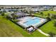 Aerial view of a pristine community pool surrounded by lounge chairs and vibrant landscaping at 2355 White Lilly Dr, Kissimmee, FL 34747