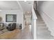 Inviting foyer featuring tile flooring, a staircase, and stylish decor at 2355 White Lilly Dr, Kissimmee, FL 34747