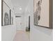 Bright hallway with neutral walls adorned with black and white animal-themed artwork at 2355 White Lilly Dr, Kissimmee, FL 34747