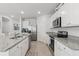Clean kitchen with white cabinets, granite countertops, and stainless steel appliances at 2355 White Lilly Dr, Kissimmee, FL 34747