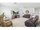 Comfortable living room featuring modern decor, ample seating, and a large television at 2355 White Lilly Dr, Kissimmee, FL 34747