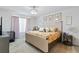 Comfortable main bedroom featuring a decorative bed frame, floral bedding, and soft lighting at 2355 White Lilly Dr, Kissimmee, FL 34747