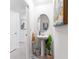 Stylish powder room with a pedestal sink, decorative mirror, and tasteful artwork at 2355 White Lilly Dr, Kissimmee, FL 34747