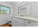 Bright bathroom featuring granite counters, white cabinetry and modern fixtures at 241 Brittany Ave, Port Orange, FL 32127