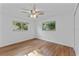Cozy bedroom features hardwood floors and windows offering bright natural light at 241 Brittany Ave, Port Orange, FL 32127