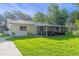 Charming single-story home with a well-maintained lawn and screened porch, perfect for outdoor enjoyment at 241 Brittany Ave, Port Orange, FL 32127
