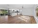 Bright open-concept kitchen with white cabinetry, a center island, stainless steel appliances, and wood flooring at 241 Brittany Ave, Port Orange, FL 32127