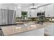 Modern kitchen featuring white cabinetry, stainless steel appliances, stone countertops, and mosaic backsplash at 241 Brittany Ave, Port Orange, FL 32127