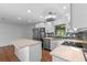 Bright modern kitchen with white cabinets, stainless appliances, island, and stylish backsplash and lighting at 241 Brittany Ave, Port Orange, FL 32127