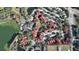 Aerial view of a community with red-roofed buildings, surrounded by lush trees, ponds and amenities at 249 Afton Sq # 112, Altamonte Springs, FL 32714