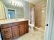 Bathroom featuring a dark vanity with a white countertop and a shower with glass doors at 249 Afton Sq # 112, Altamonte Springs, FL 32714