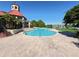 Community pool and clubhouse featuring a scenic lake view, outdoor seating and landscaped surroundings at 249 Afton Sq # 112, Altamonte Springs, FL 32714