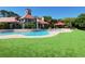 Community pool featuring manicured lawn and landscaped outdoor relaxation areas at 249 Afton Sq # 112, Altamonte Springs, FL 32714