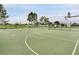 Community basketball court with full court lines and multiple hoops within a fenced green space at 2546 Oneida Loop, Kissimmee, FL 34747