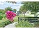 Neighborhood park with bench and playground equipment visible through a canopy of mature trees at 2546 Oneida Loop, Kissimmee, FL 34747
